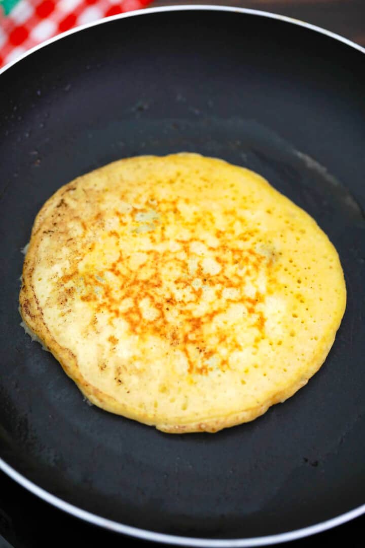 cooking the pancakes on the skillet.