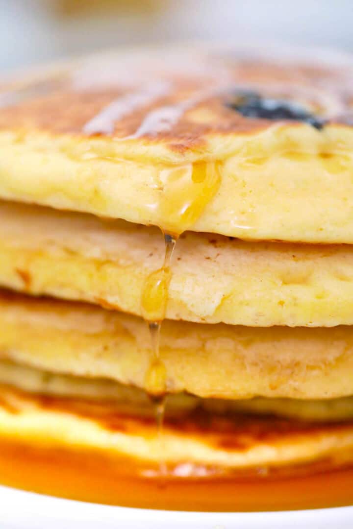 closeup of syrup dripping down the pancakes.