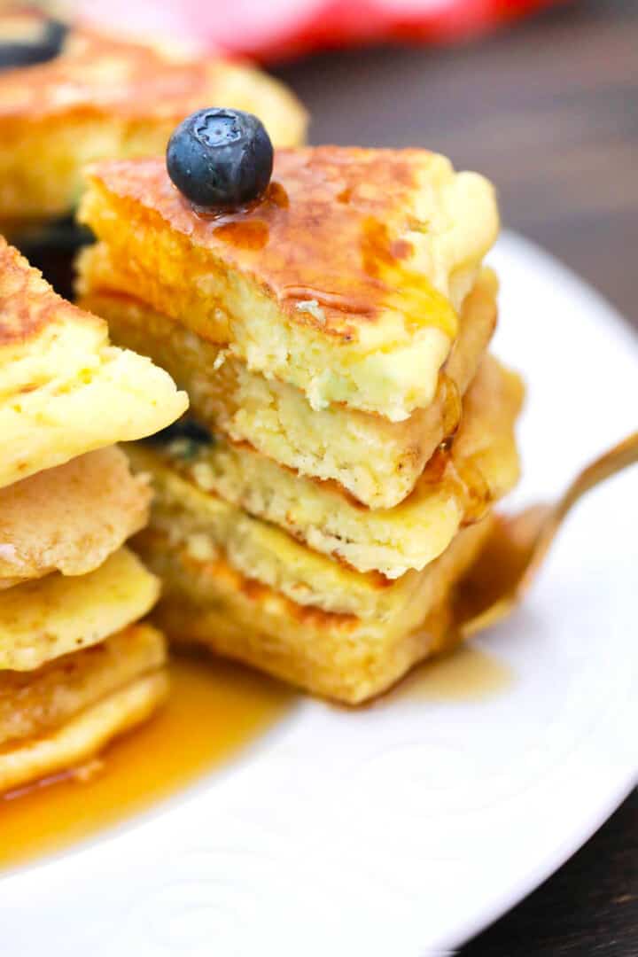 stacked pancakes topped with syrup.