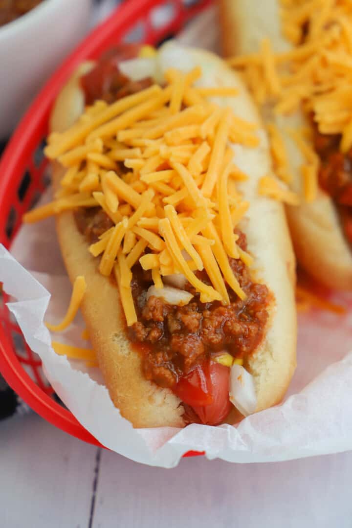 closeup of hot dog with chili and cheese on top