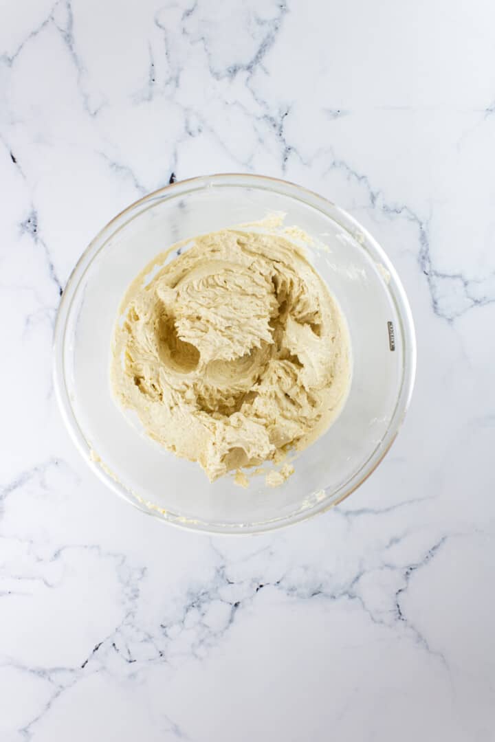 mixing dough in a clear mixing bowl