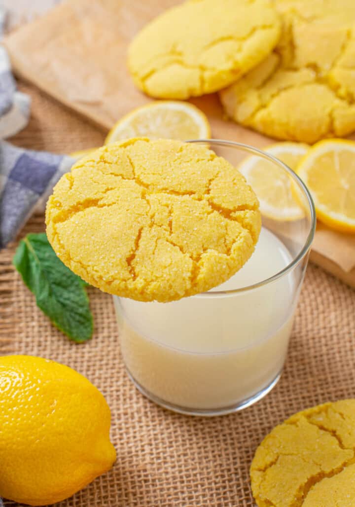 lemon sugar cookie sitting on a glass of milk
