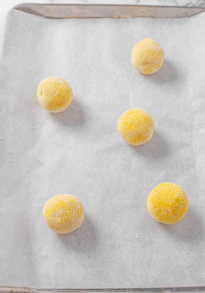 lemon sugar cookie dough balls on baking sheet with parchment paper