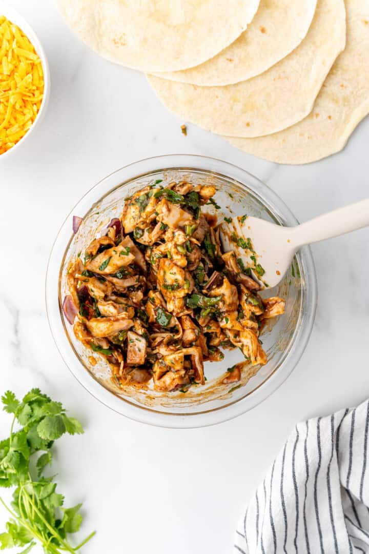 mixing quesadilla ingredients in the glass bowl