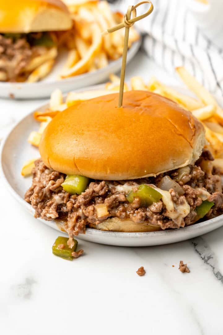 Philly Cheesesteak Sloppy Joes on white plate with fries