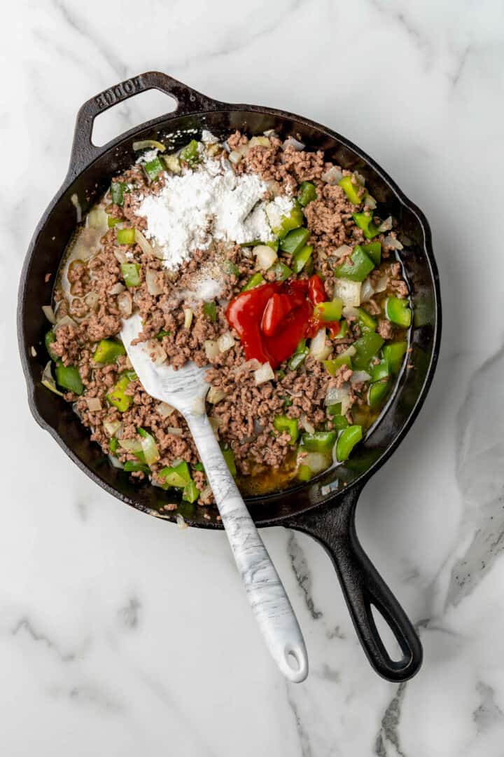 adding in remaining ingredients to the sloppy joes