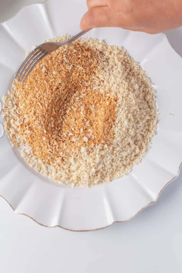 covering the tenders in the breadcrumbs.