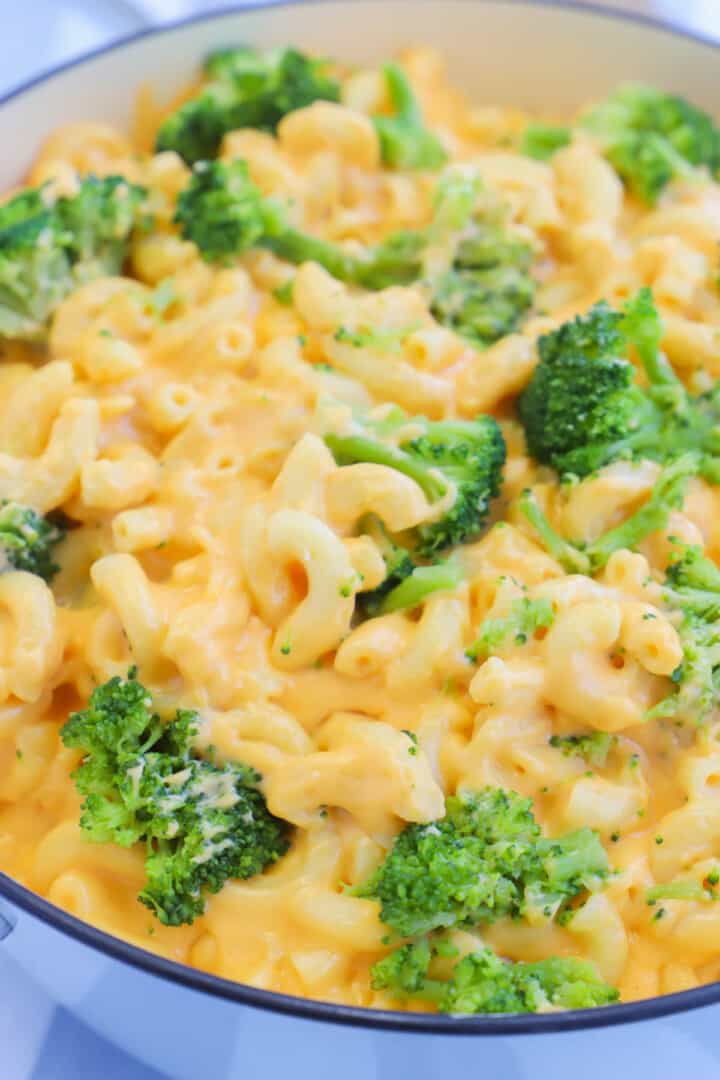 adding the broccoli to the mac and cheese.
