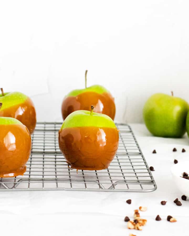 caramel apples on wire rack cooling.