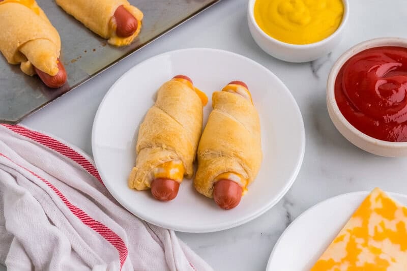 two dogs cooked and placed on a white plate