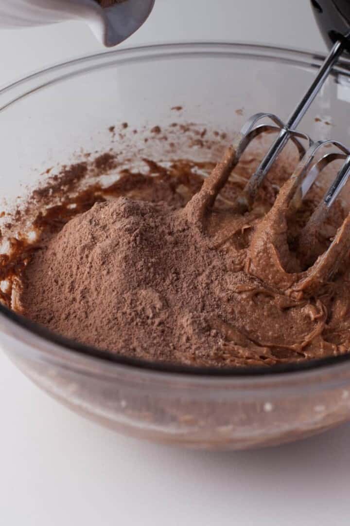 adding wet and dry ingredients together for cookie dough.