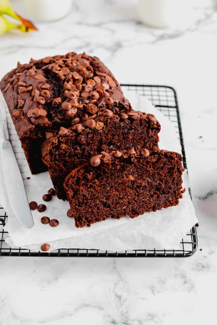 Double Chocolate Banana Bread sliced on wire rack.