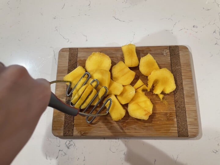 mashing the peaches for the syrup.