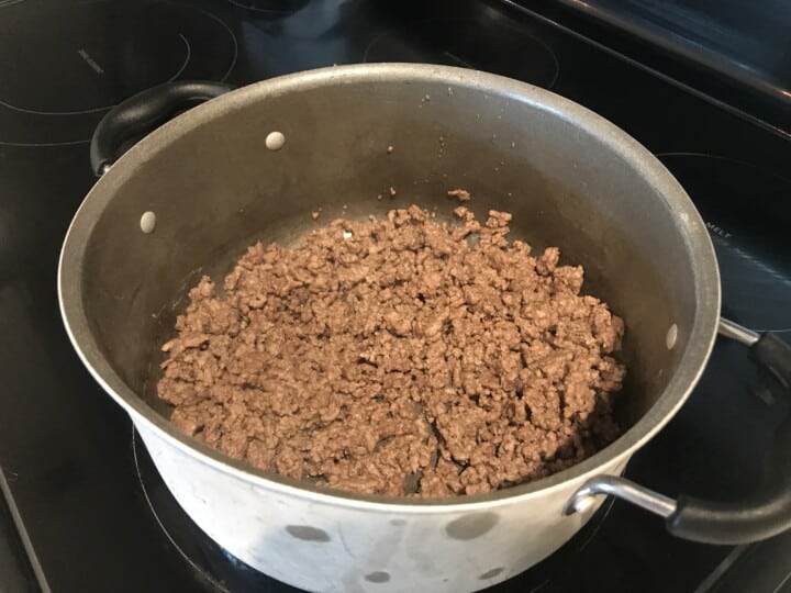 cooking the beef in a large pot.