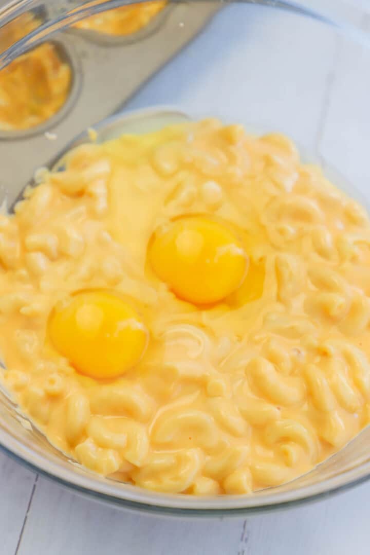 adding eggs to the mac and cheese.