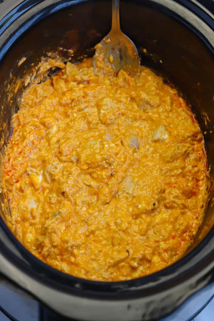 Buffalo chicken dip cooked in slow cooker.