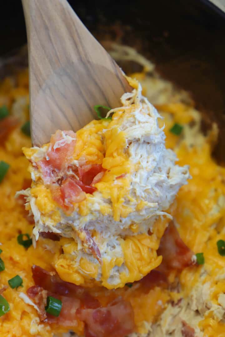 closeup of crack chicken on wooden spoon.