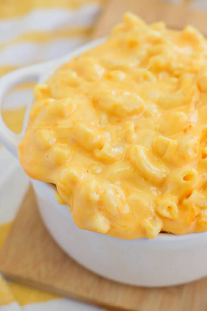 Velveeta Mac and Cheese in white bowl on wooden serving board