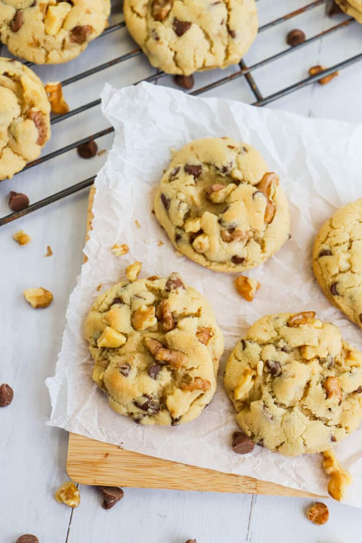 Walnut Chocolate Chip Cookies on wooden serving board and wire rack.