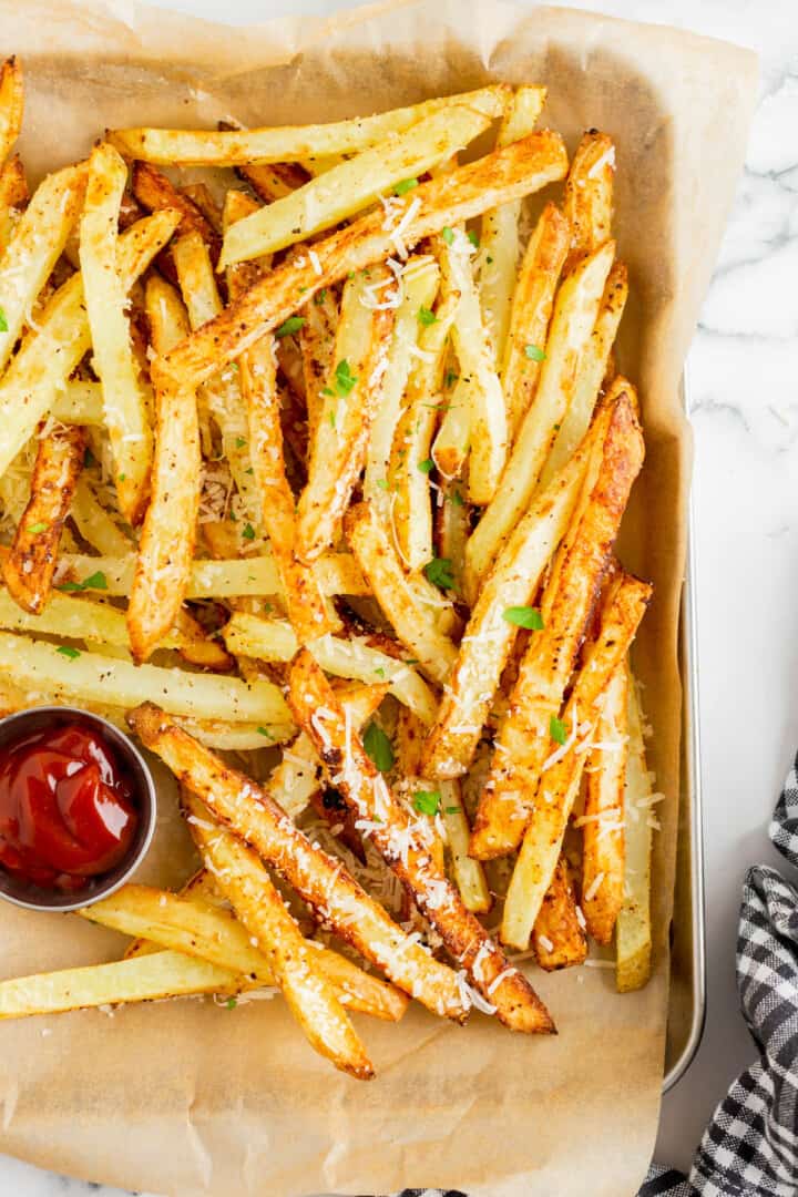 Garlic Parmesan Fries on metal serving tray with ketchup.