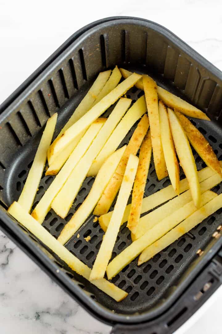 French fries in air fryer basket.