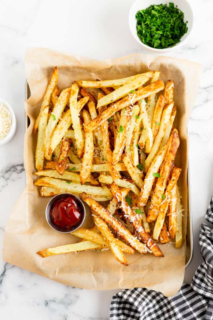 Air Fryer Parmesan Fries on serving tray with ketchup.
