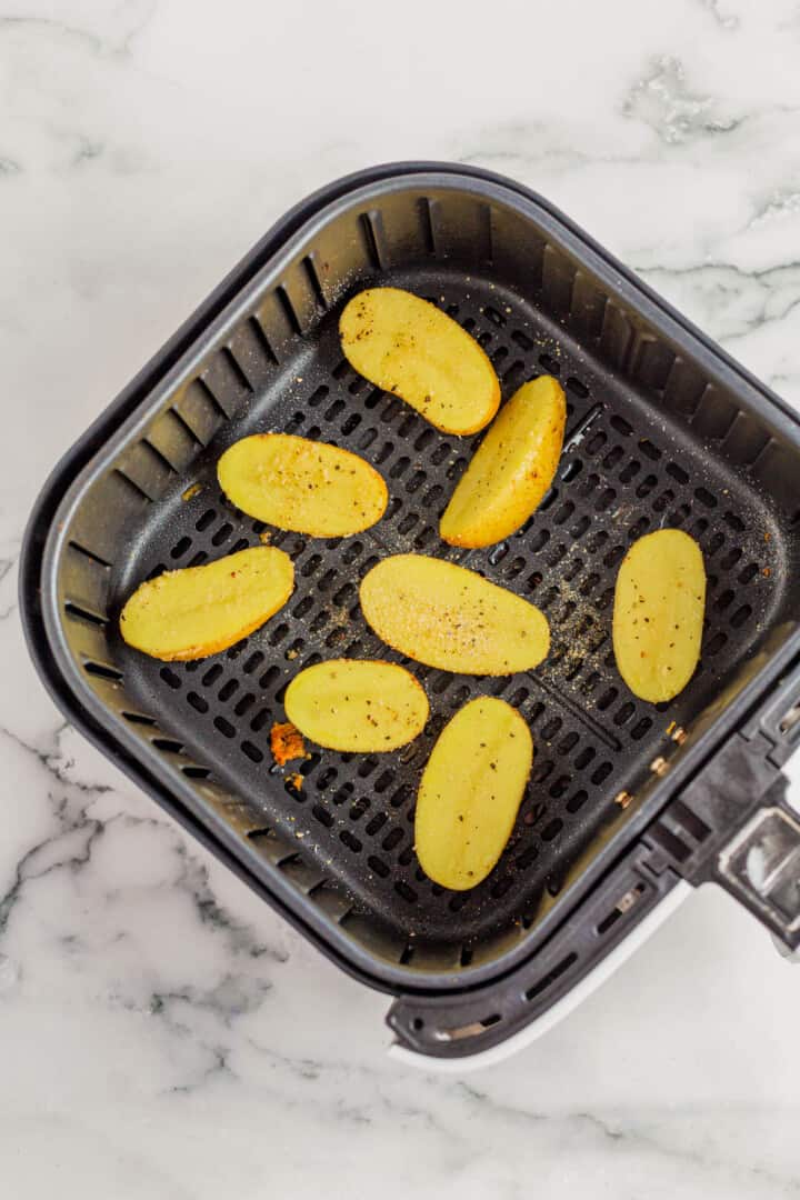 potatoes in air fryer basket.