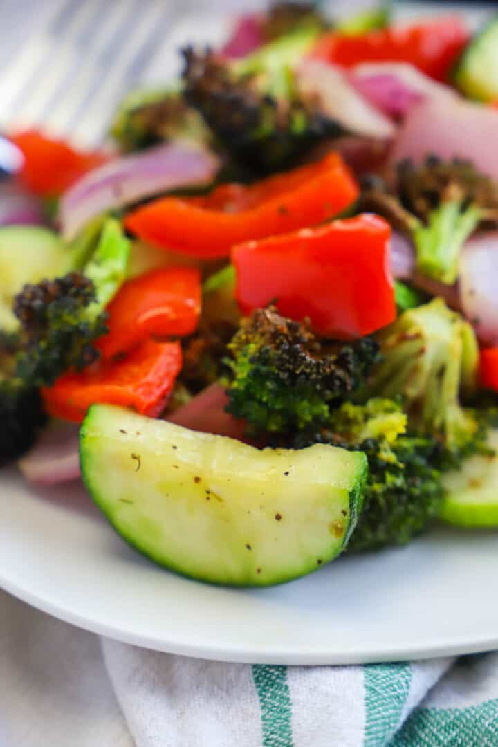 closeup of Air Fryer Vegetables on a white plate.