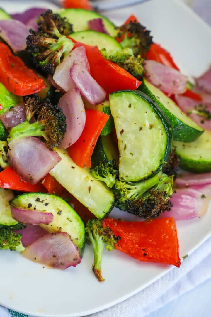 closeup of air fryer vegetables on a white plate.