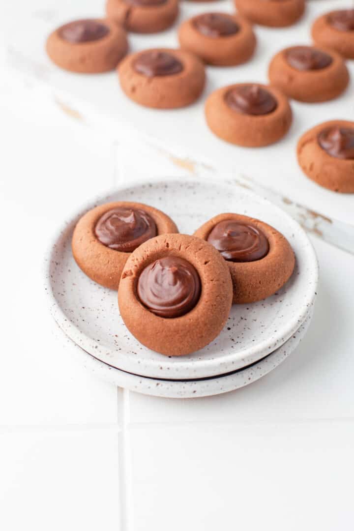 Three Chocolate Thumbprint Cookie on small plate. 