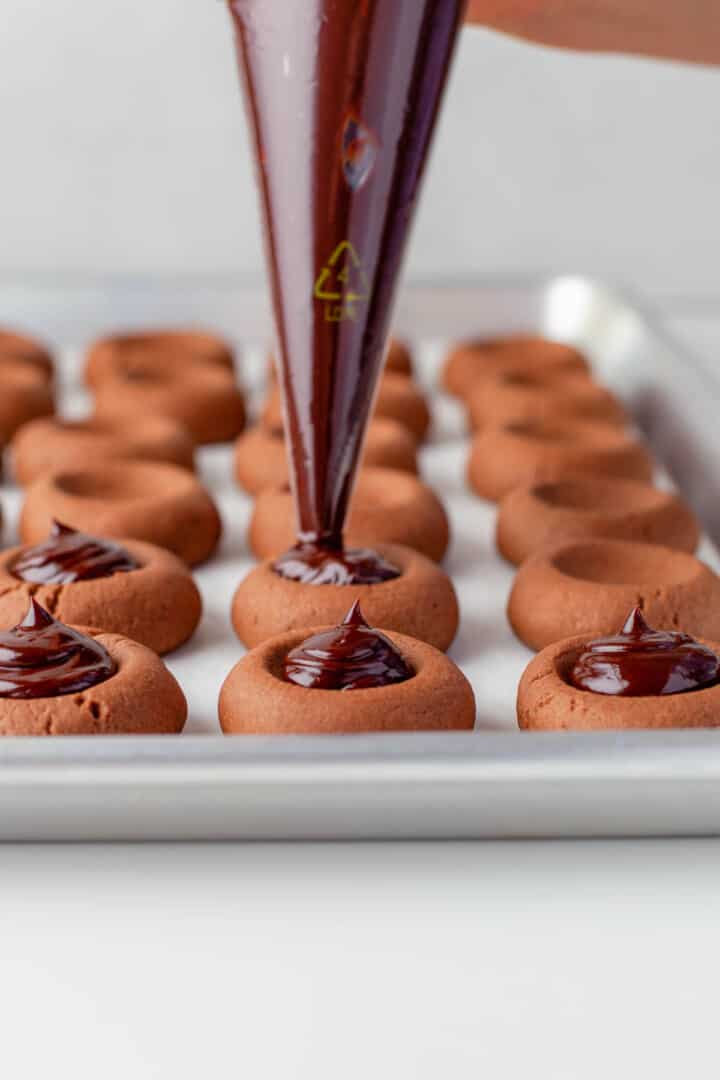 piping the ganache on the baked cookies.