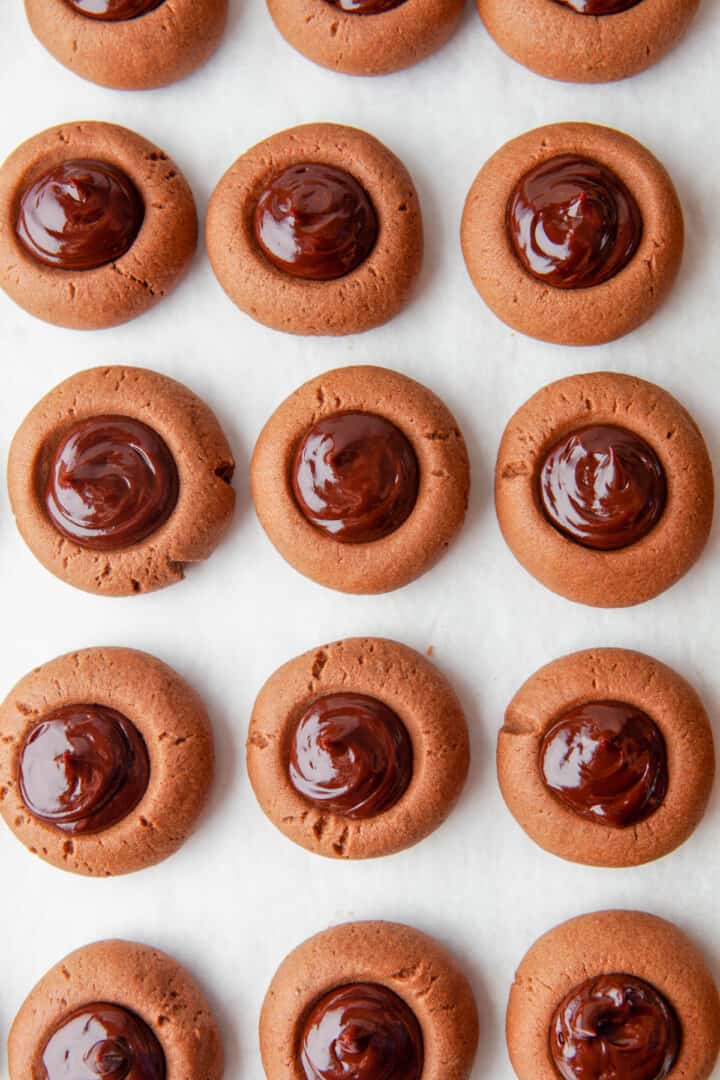 chocolate thumbprint cookies on white counter.