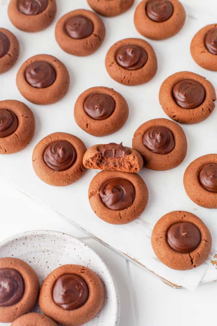 chocolate thumbprint cookies on baking sheet.