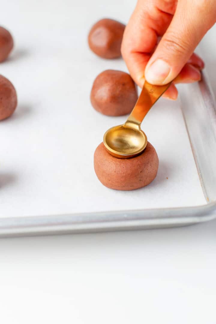 making the thumbprint in the cookie dough