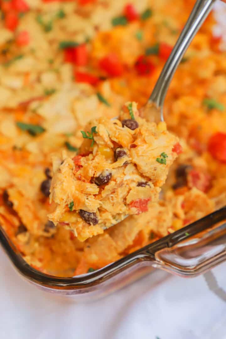 Mexican chicken casserole on metal spoon.