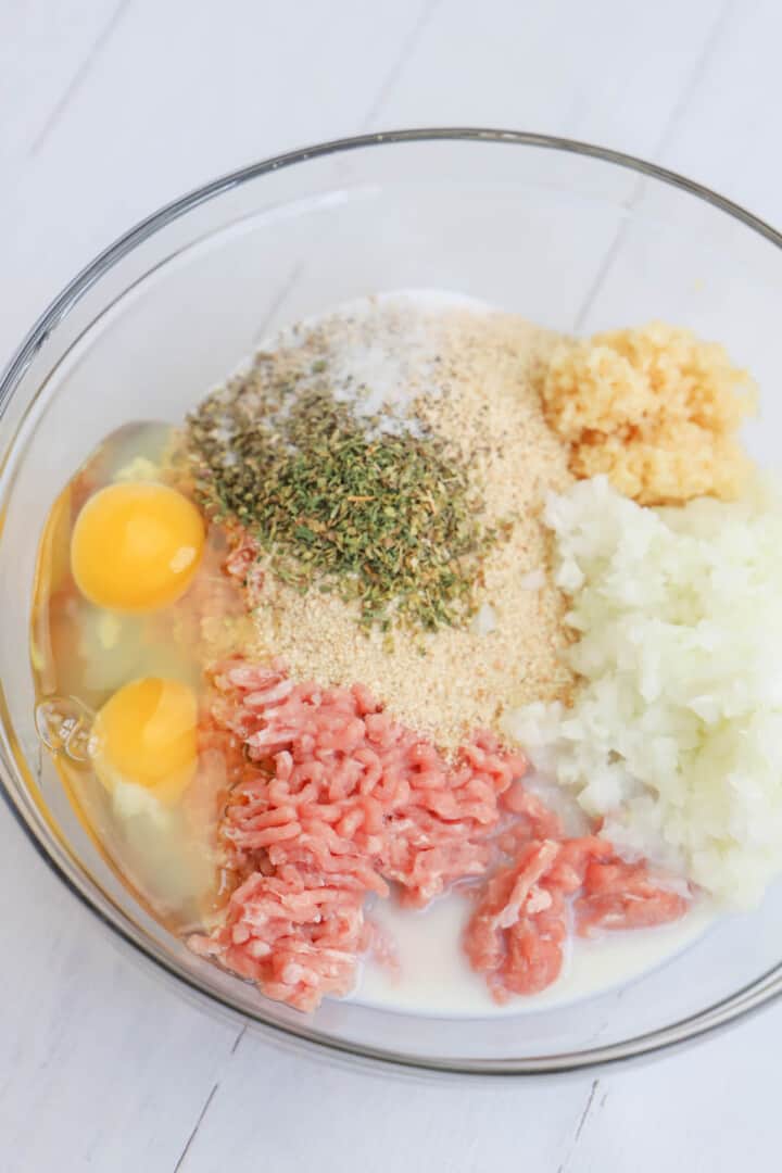 ingredients for turkey meatballs in glass bowl.
