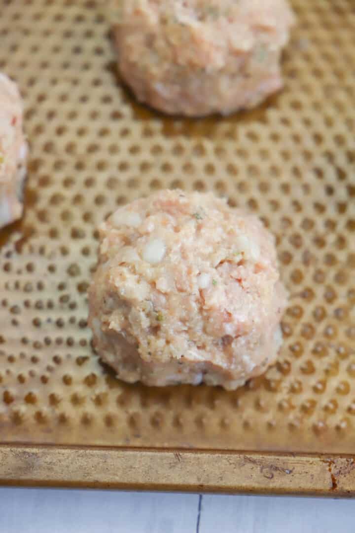 formed meatball on baking sheet.