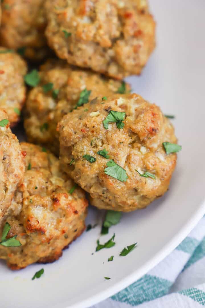 closeup of meatballs on white serving tray.