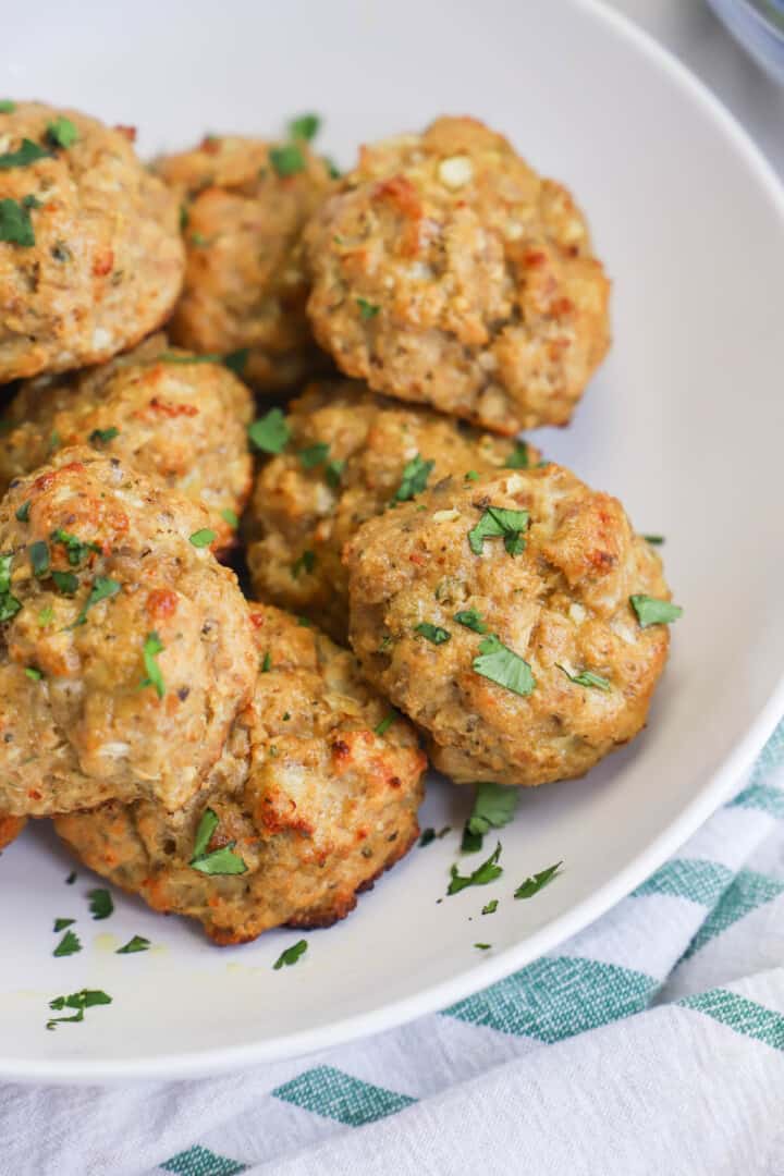 closeup of turkey meatballs on a white serving tray.