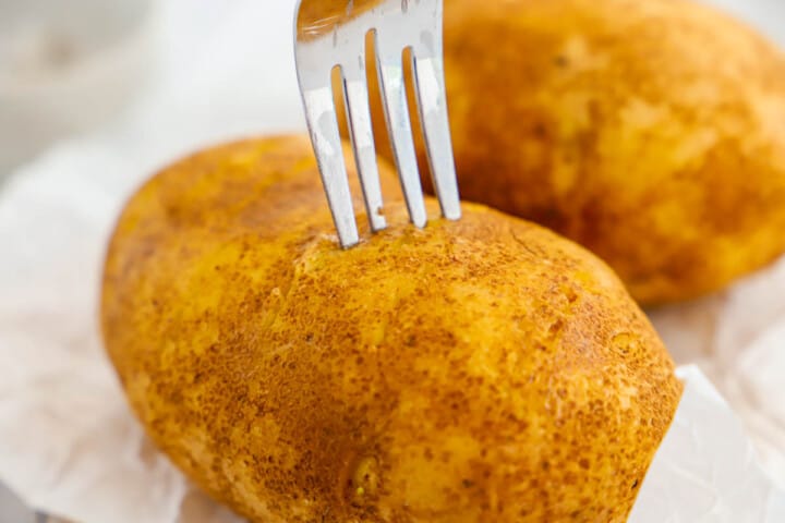 poking holes in the potato with a fork.