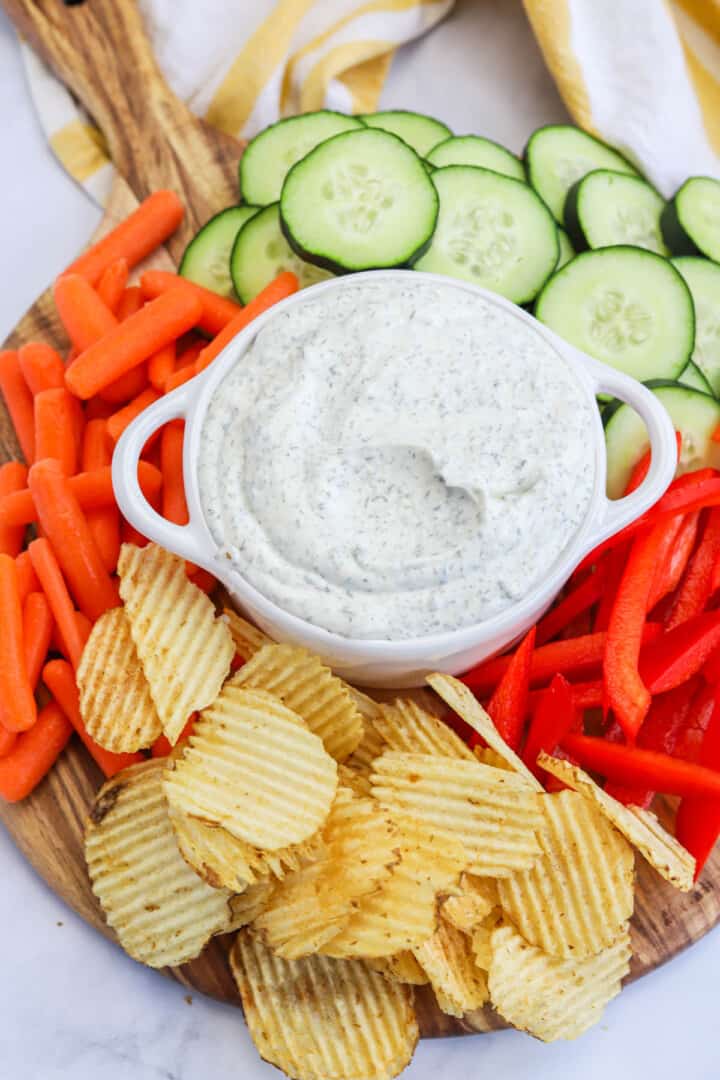 closeup of Dill Dip on serving board with veggies and chips.