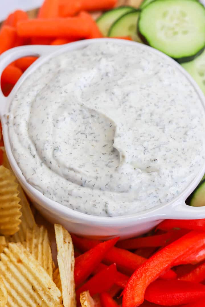 closeup of Dill Dip on serving board with veggies and chips.