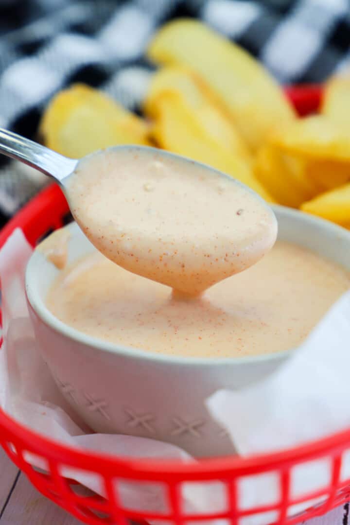 scooping the fry sauce out with a spoon.