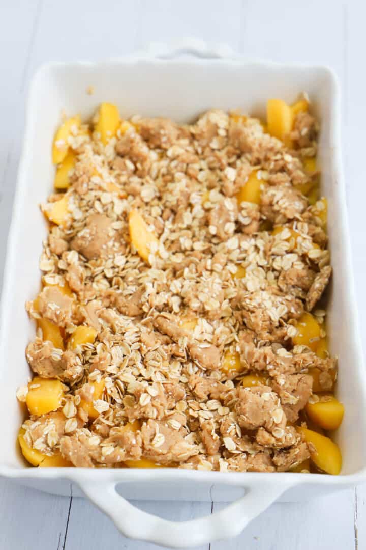 peach crisp in baking dish before going in the oven.