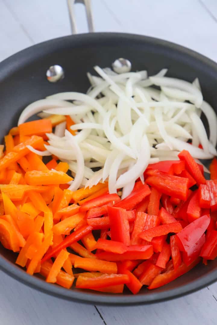 bell peppers and onions in a skillet.
