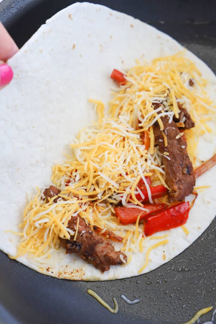 making the steak quesadilla on the skillet.