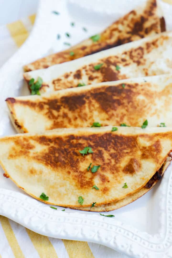 steak quesadillas on white serving plate.