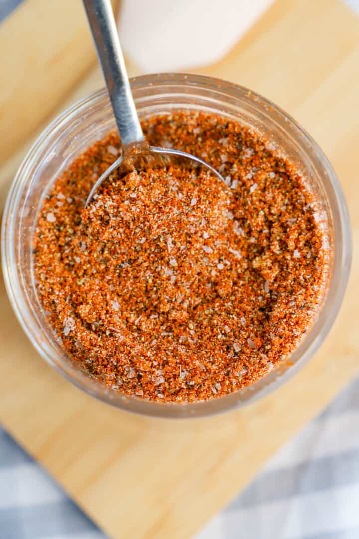 using spoon to scoop steak rub.