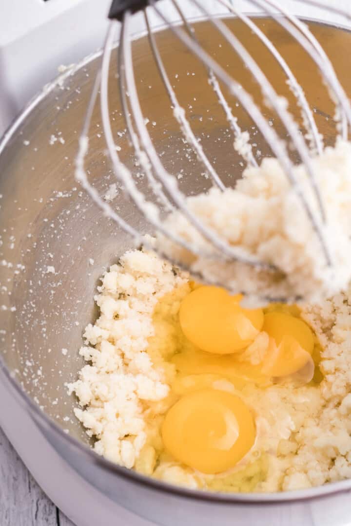 adding eggs to the butter and sugar mixture