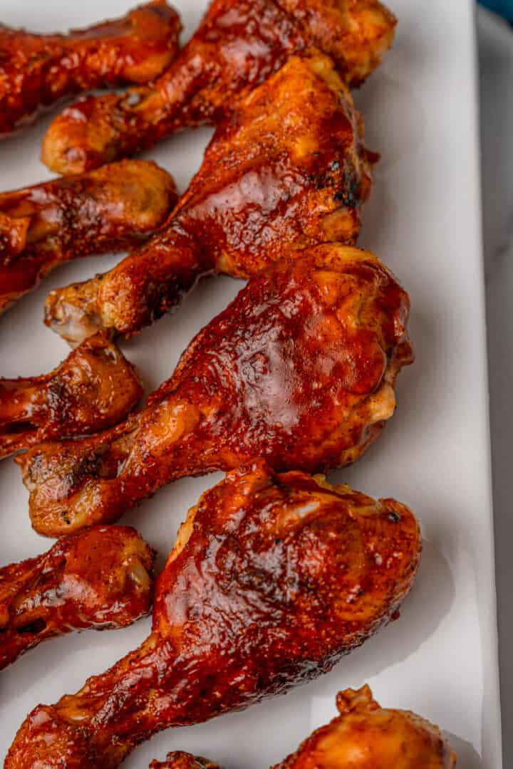 BBQ Chicken Drumsticks on white serving tray.